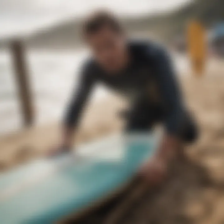 A surfer performing maintenance on a surfboard with tools