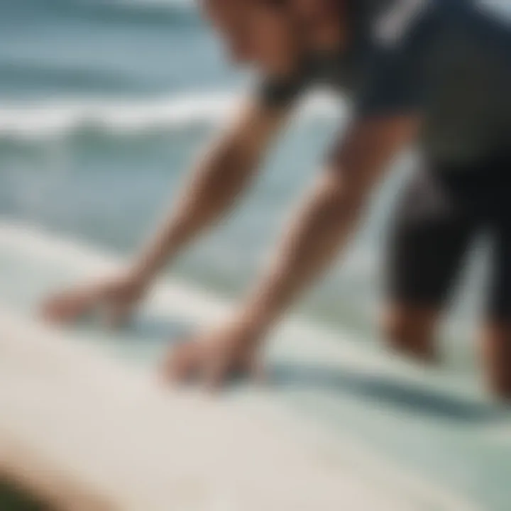 A surfer demonstrating the application of grip pads on a surfboard