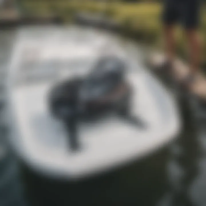 A close-up of a wakeboard being loaded onto a pontoon boat rack