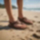 OluKai Ohana sandals on a beach setting