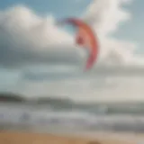 A vibrant trainer kite soaring high in the sky with a scenic beach backdrop