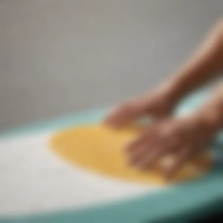 Close-up of wax application on a skimboard