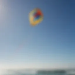 A vibrant kite soaring against a clear blue sky during a kite sailing session.