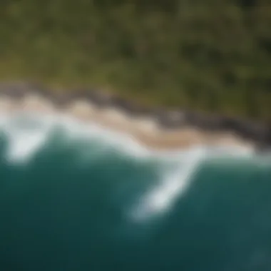 Aerial view of a rugged coastline with surfers in the water