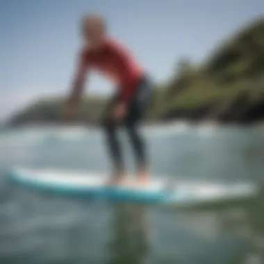 A beginner surfer practicing balance on a soft top surfboard