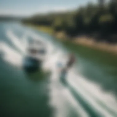 An aerial shot of a wakeboarder performing a trick behind a boat