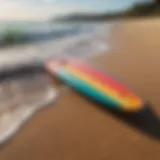 A vibrant short foam surfboard on a sandy beach