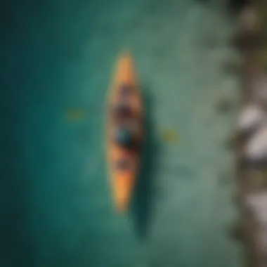 An aerial shot of a group of kayakers paddling through crystal clear waters.