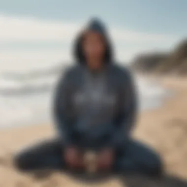 Surfer relaxing on the beach in a stylish surf changing hoodie