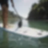 Examine the surface of a paddle board for wear and tear