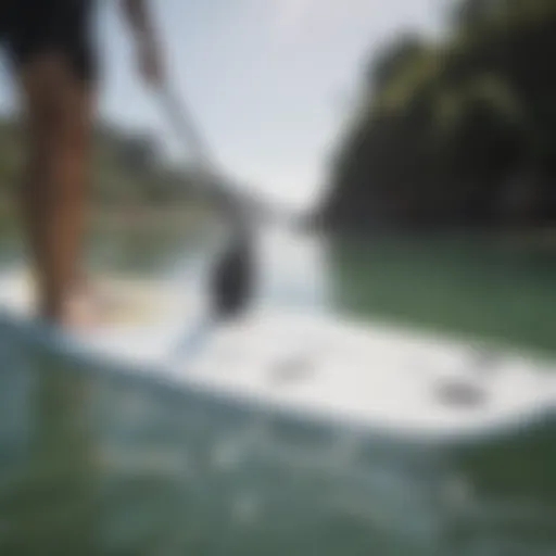 Examine the surface of a paddle board for wear and tear