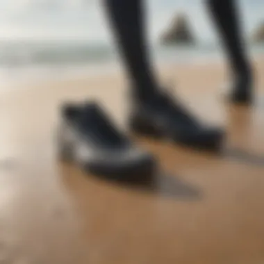 Wetsuit shoes displayed on a sandy beach